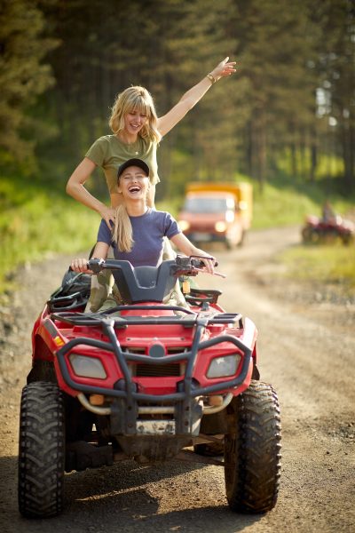Two,girlfriends,driving,quad,together,in,the,nature;,active,vacation