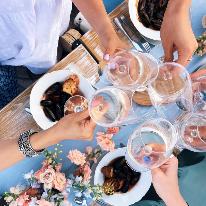Group,of,friends,cheering,with,glasses,of,white,wine,above