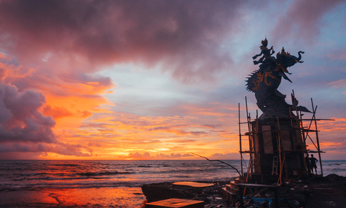 Sunset with shiva statue on pererenan beach bali
